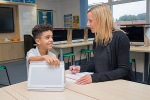 A female teacher with a young boy, taking part in a CAP assessment
